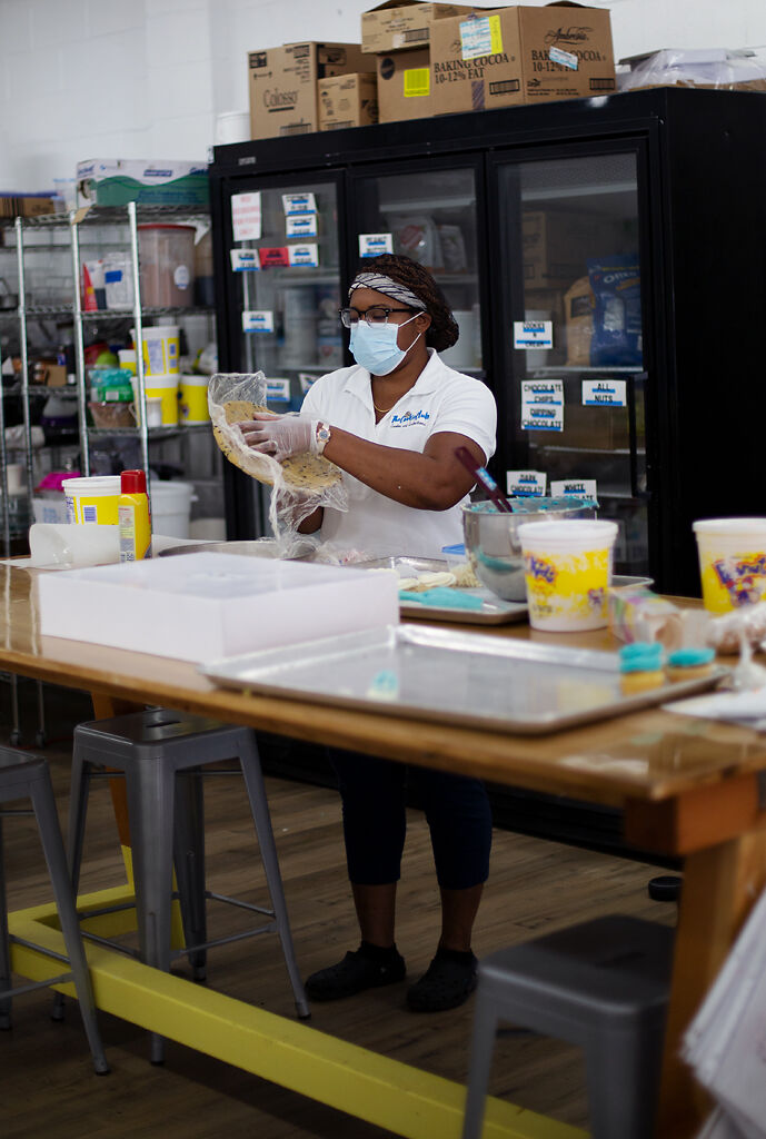 Kiarah Harris prepares a large cookie for decoration
